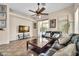 Comfortable living room features a ceiling fan and sliding glass doors to the backyard at 8968 W Adam Ave, Peoria, AZ 85382