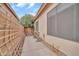 Cozy side patio with exercise equipment, privacy lattice, and a neutral-toned exterior at 8968 W Adam Ave, Peoria, AZ 85382