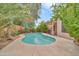 Private backyard pool surrounded by lush landscaping, creating a serene oasis at 8968 W Adam Ave, Peoria, AZ 85382