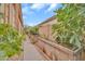Property side yard featuring a gravel walkway and garden beds surrounded by mature trees, providing privacy at 8968 W Adam Ave, Peoria, AZ 85382