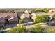 Aerial view of a landscaped single-Gathering home featuring a tile roof, and a three-car garage at 9764 E Thornbush Ave, Mesa, AZ 85212