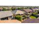 Aerial view of a home showing a backyard oasis, a patio, a gazebo, manicured turf, and desert landscaping at 9764 E Thornbush Ave, Mesa, AZ 85212