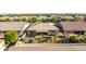 Aerial view of a single-Gathering home displaying its well-maintained backyard oasis and desert landscaping at 9764 E Thornbush Ave, Mesa, AZ 85212