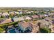 Expansive aerial view of a Primary-planned community with tile roofs and lush landscaping at 9764 E Thornbush Ave, Mesa, AZ 85212