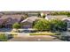 Aerial view of a single-Gathering home showcasing desert landscaping, a three-car garage, and a tile roof at 9764 E Thornbush Ave, Mesa, AZ 85212