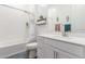 Bright bathroom features a white vanity and a tub shower with white subway tile at 9764 E Thornbush Ave, Mesa, AZ 85212