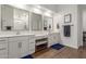 Elegant bathroom featuring double sinks, a vanity area, modern fixtures, and wooden tile flooring at 9764 E Thornbush Ave, Mesa, AZ 85212