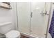 Bright bathroom features a white toilet and walk-in shower with glass door and sleek hardware at 9764 E Thornbush Ave, Mesa, AZ 85212