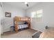 Functional bedroom with a wooden bunk bed, a chair, and a table, perfect for or guests at 9764 E Thornbush Ave, Mesa, AZ 85212