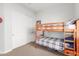 Cozy bedroom with a wooden bunk bed and closet, providing a comfortable and organized space at 9764 E Thornbush Ave, Mesa, AZ 85212