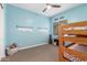 Bedroom features light blue walls, bunk beds, and a cozy atmosphere for  at 9764 E Thornbush Ave, Mesa, AZ 85212