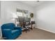 This bedroom includes a desk with dual monitors, a comfortable chair, and natural light from the window at 9764 E Thornbush Ave, Mesa, AZ 85212