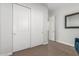 This bedroom includes a closet with sliding doors, neutral carpet, and a neutral color palette at 9764 E Thornbush Ave, Mesa, AZ 85212