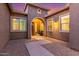Inviting home entrance with an arched doorway and manicured landscaping at 9764 E Thornbush Ave, Mesa, AZ 85212