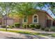 Charming single-story home with a well-maintained lawn, mature trees, and neutral color palette at 9764 E Thornbush Ave, Mesa, AZ 85212