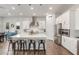 Modern kitchen with stainless steel appliances, oversized island with seating, and wood-look flooring at 9764 E Thornbush Ave, Mesa, AZ 85212