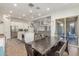 Open-concept kitchen and dining area with modern lighting, neutral colors, and seamless flow at 9764 E Thornbush Ave, Mesa, AZ 85212