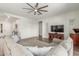 Open living room featuring a large sofa, neutral decor, and a ceiling fan for comfort at 9764 E Thornbush Ave, Mesa, AZ 85212
