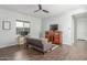 Cozy living room with wood floors, neutral walls, a TV, and comfortable seating at 9764 E Thornbush Ave, Mesa, AZ 85212