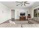 Bright living room with a ceiling fan, TV, and comfortable gray sofa at 9764 E Thornbush Ave, Mesa, AZ 85212
