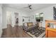 Inviting living area with a gray sofa, wooden floors, and built-in storage, creating a cozy and organized space at 9764 E Thornbush Ave, Mesa, AZ 85212