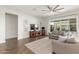 Living area with comfortable seating, wood floors, neutral decor, and access to the patio at 9764 E Thornbush Ave, Mesa, AZ 85212