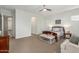 Spacious main bedroom with a cozy sitting area, side tables with lamps, and plush carpet at 9764 E Thornbush Ave, Mesa, AZ 85212