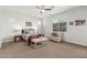 Serene main bedroom with a comfortable seating area, and a wooden bed frame, creating a relaxing retreat at 9764 E Thornbush Ave, Mesa, AZ 85212
