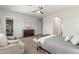 Well-lit main bedroom with a dresser, plush chair, and ensuite bath, providing ample space and comfort at 9764 E Thornbush Ave, Mesa, AZ 85212