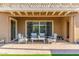 Charming patio with comfortable outdoor seating and a view of the well-maintained backyard at 9764 E Thornbush Ave, Mesa, AZ 85212