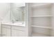 Bright bathroom with double vanity sinks and linen shelving at 10608 W Sonrisas St, Tolleson, AZ 85353