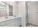 Bathroom featuring double sinks, vanity, and walk-in shower at 10608 W Sonrisas St, Tolleson, AZ 85353