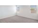 Clean, empty bedroom with carpet flooring and natural light from the windows at 10608 W Sonrisas St, Tolleson, AZ 85353