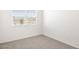 Bright empty bedroom with neutral carpet and a window offering natural light at 10608 W Sonrisas St, Tolleson, AZ 85353