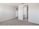 Spacious carpeted bedroom near the bathroom and closet spaces at 10608 W Sonrisas St, Tolleson, AZ 85353