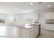 Bright kitchen featuring white cabinetry, granite countertops, stainless steel appliances, and a connected living space at 10608 W Sonrisas St, Tolleson, AZ 85353
