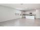Eat in kitchen featuring modern white cabinets, granite countertops, and stainless steel appliances for a functional and stylish cooking space at 10608 W Sonrisas St, Tolleson, AZ 85353