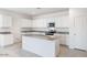 Bright kitchen featuring white cabinetry, granite countertops, and stainless steel appliances at 10608 W Sonrisas St, Tolleson, AZ 85353