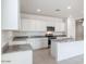 Bright kitchen featuring white cabinetry, granite countertops, and stainless steel appliances at 10608 W Sonrisas St, Tolleson, AZ 85353