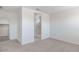 Carpeted primary bedroom with en-suite bathroom featuring shower and a walk-in closet, creating a private retreat at 10608 W Sonrisas St, Tolleson, AZ 85353