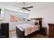 Bedroom with hardwood floors, large window, wooden bedframe, and side tables at 11256 E Sunnyside Dr, Scottsdale, AZ 85259