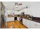 Spacious kitchen with white cabinets, stainless steel appliances, granite countertops, and hardwood floors at 11256 E Sunnyside Dr, Scottsdale, AZ 85259