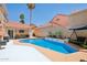 Inviting backyard pool area with a tiled pool, seating, and a lush tropical landscaping at 11256 E Sunnyside Dr, Scottsdale, AZ 85259