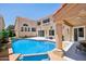 Stunning pool area with covered patio featuring architectural columns and manicured landscaping at 11256 E Sunnyside Dr, Scottsdale, AZ 85259