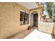 Charming front entrance with an arched doorway, window, and a small potted plant for a welcoming touch at 1126 W Elliot Rd # 2023, Chandler, AZ 85224