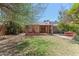 Backyard featuring a patio, lawn, mature trees, and red outdoor dining set at 1134 W Portland St, Phoenix, AZ 85007