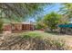 Backyard featuring a covered patio, lawn, mature trees, and dining set at 1134 W Portland St, Phoenix, AZ 85007