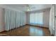 Bright bedroom featuring hardwood floors, a ceiling fan, and white curtains at 1134 W Portland St, Phoenix, AZ 85007