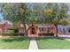 Charming front yard featuring lush green grass, mature trees and a well-maintained landscape at 1134 W Portland St, Phoenix, AZ 85007