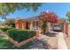 Lovely exterior of home with colorful accents, mature landscaping, and a covered carport at 1134 W Portland St, Phoenix, AZ 85007